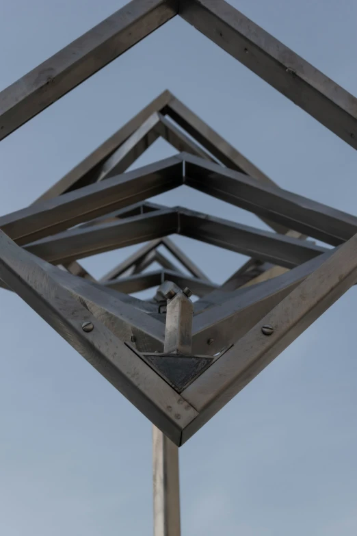 a metal frame with a small bird on top