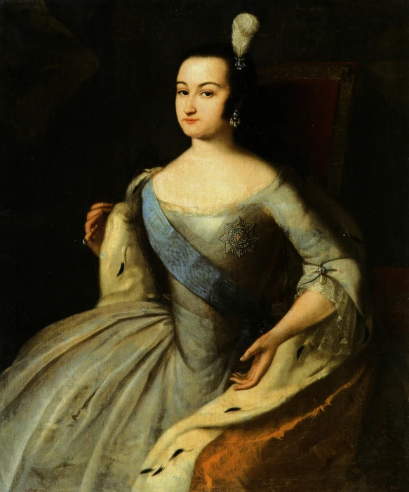 a woman in blue and white dress and gold celet
