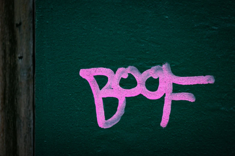 graffiti painted on a green wall with the word poof