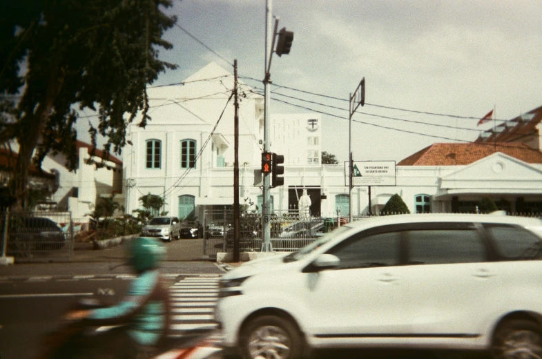 a car is passing by a person on the street