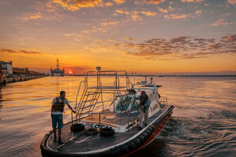 two people standing on top of a boat with a sky background