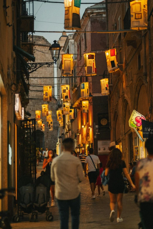 a city street at dusk with people on the sidewalks