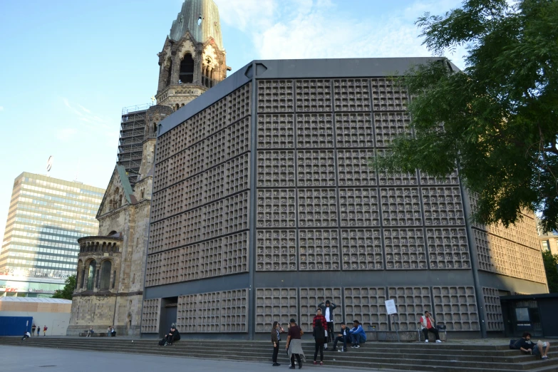 several people standing outside an architectural building in a city