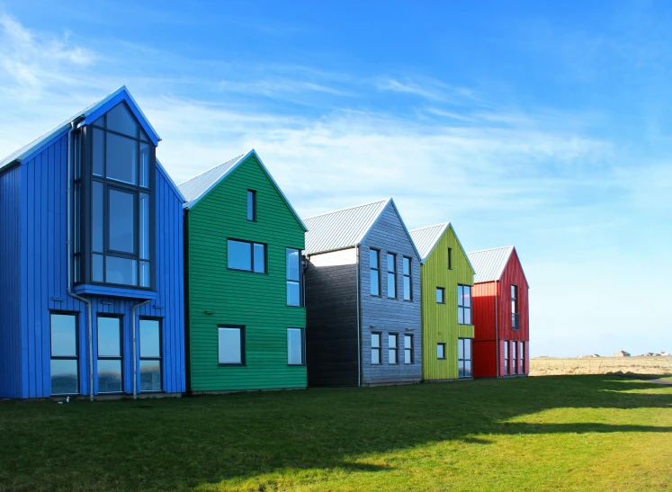 a line of houses on a grass field