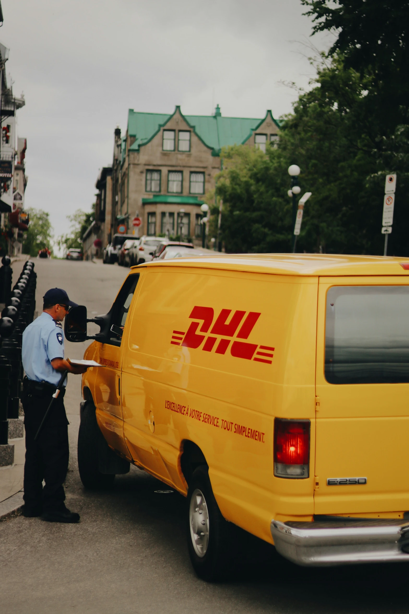 a man using the side of a yellow van to get soing from a van