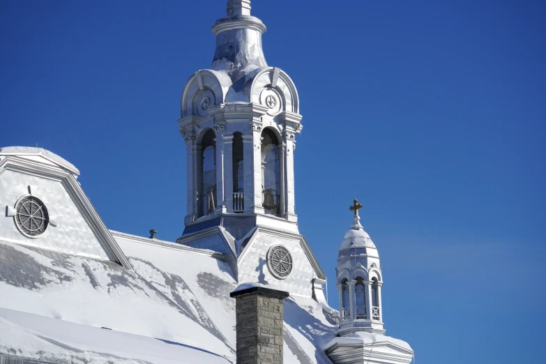 a building that has a steeple and two bell towers on top of it