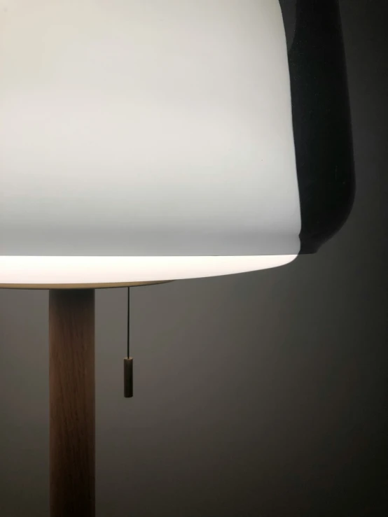 a wooden table lamp is dim lighting on it
