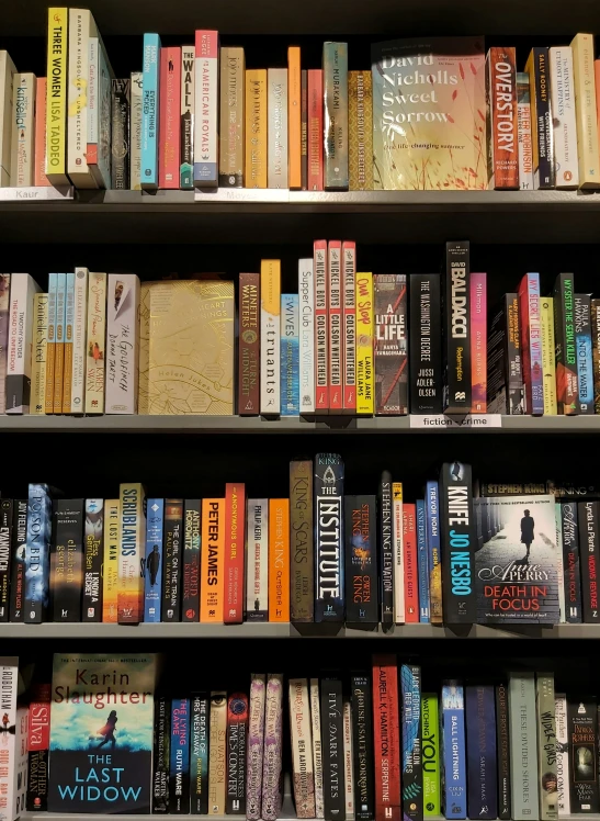 a book shelf filled with books and writing paper