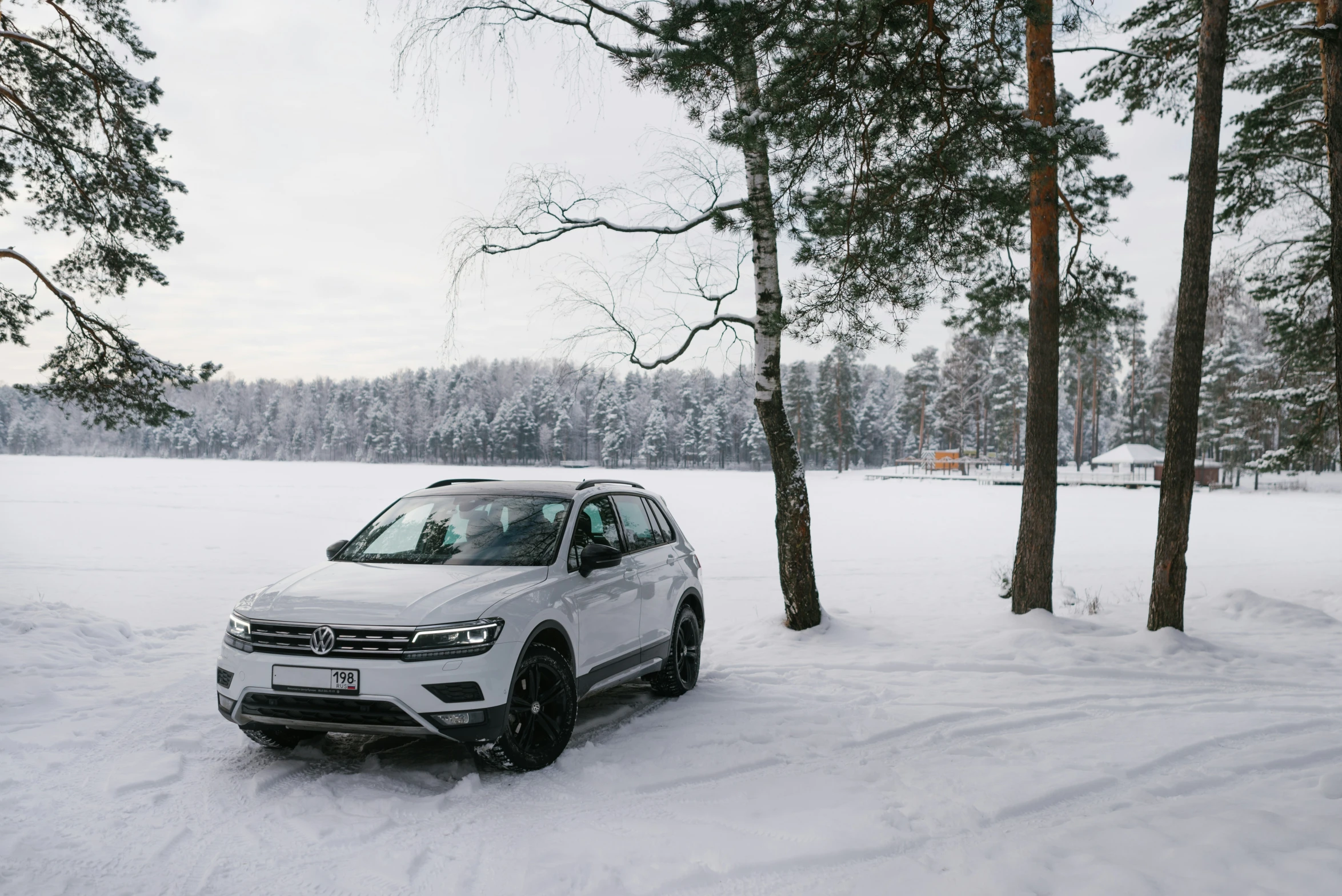 a silver and white car sitting in the snow