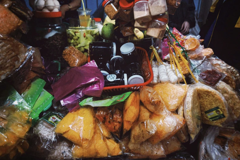 a table filled with lots of fruit and a pile of packages