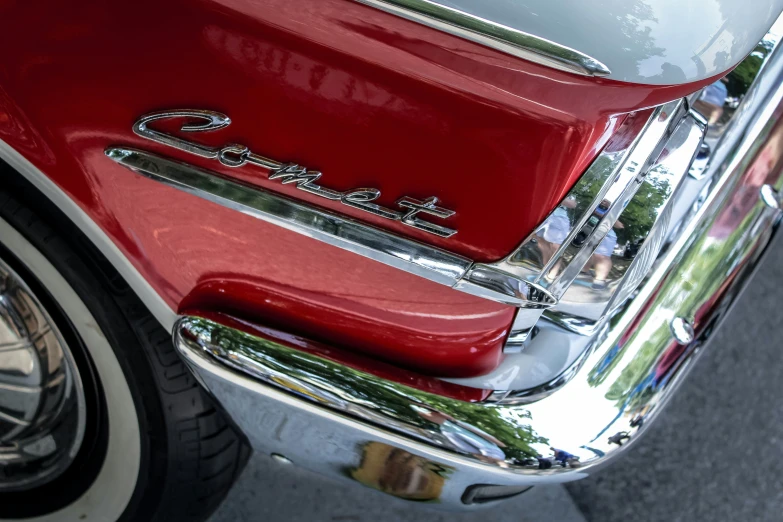 an old red car with chrome lettering is shown