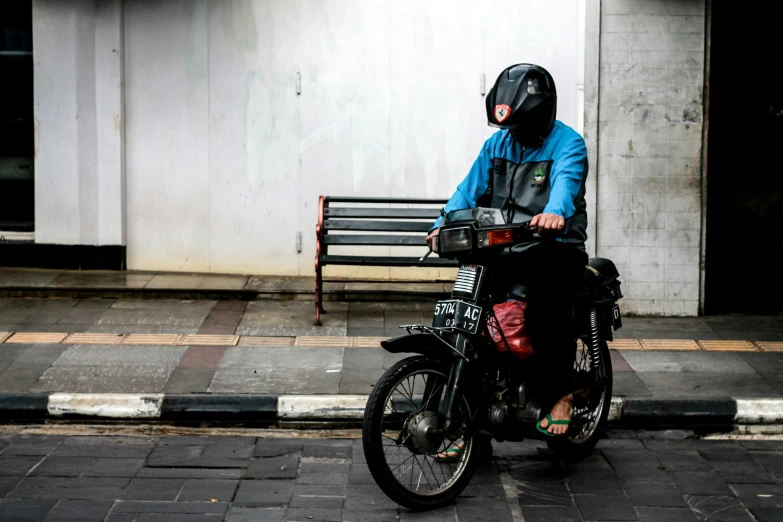 a person is riding a motorcycle near a bench