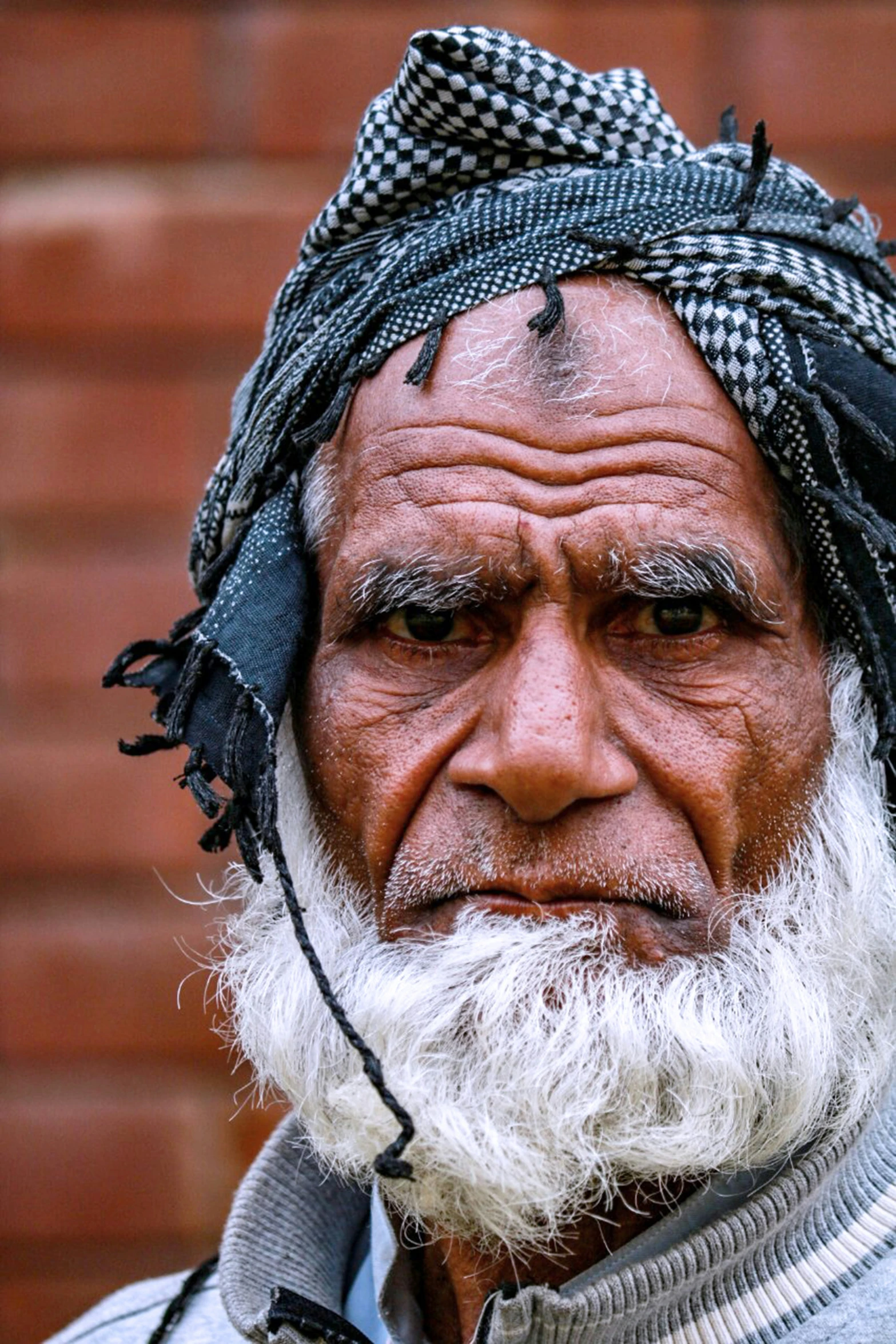 an old man with a big white beard and wearing a head piece