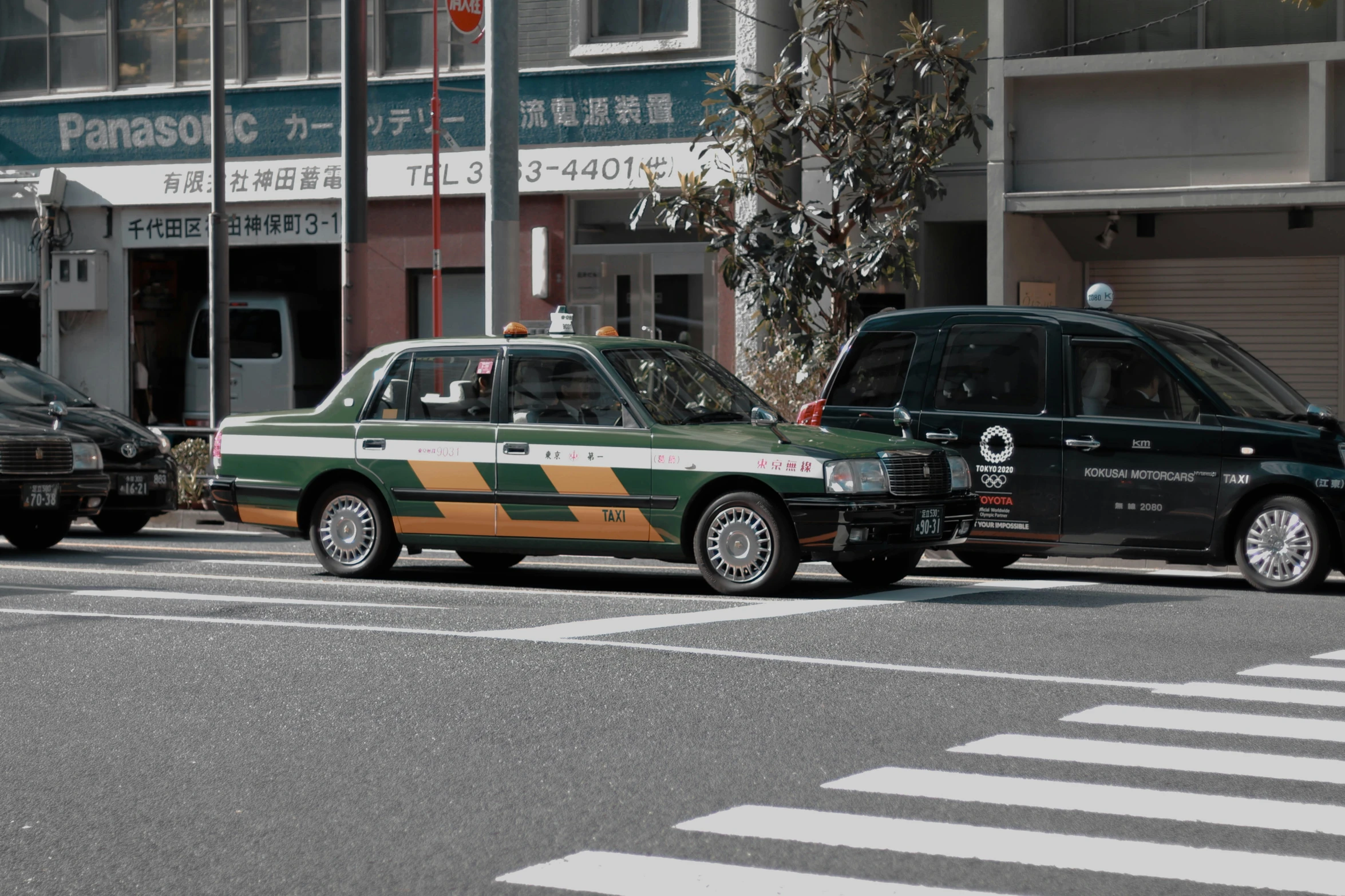 a taxi driving in front of a police car