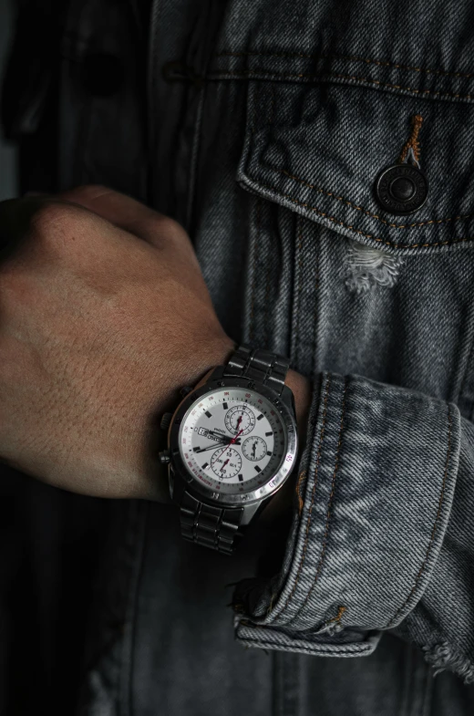 a hand on a man wearing a watch with two hands