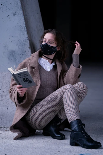 a person wearing a mask and reading a book