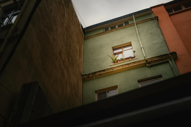 an open window in the top floor of a building