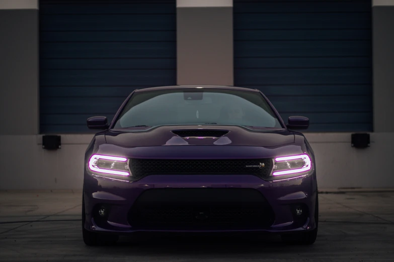 a dark purple car sitting in a parking lot