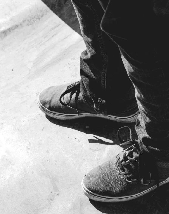 an image of a black and white po of a person wearing sneakers