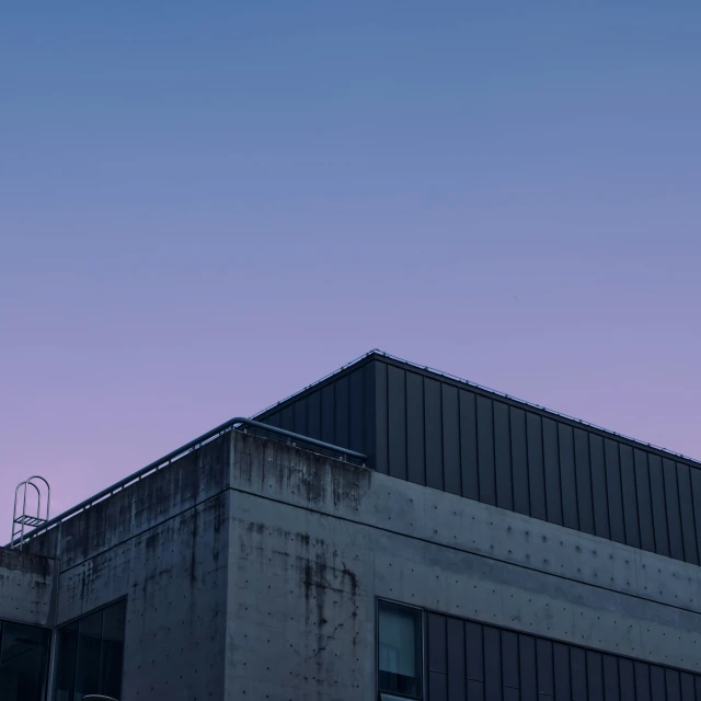 an airplane flying by on a purple sky