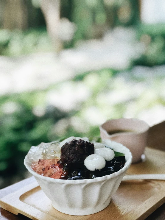 a bowl of stew sits on the side of a  board