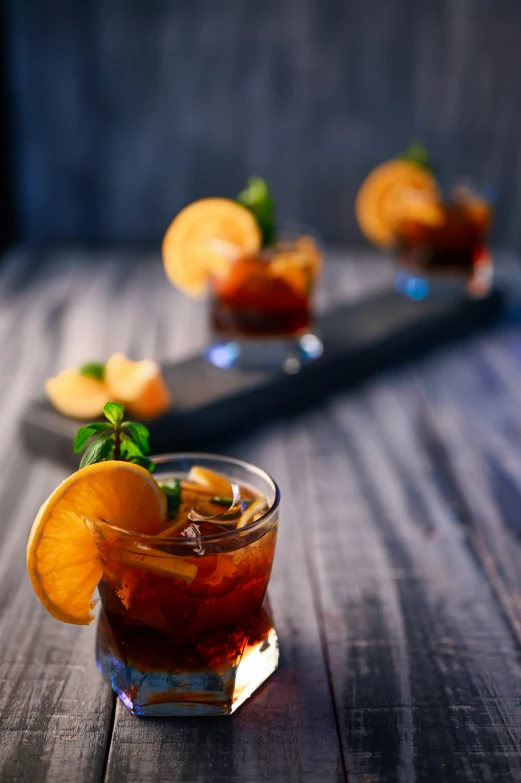 a glass cup filled with a cocktail on top of a wooden table