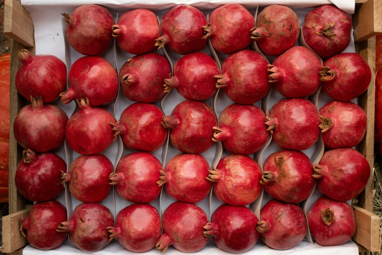 a bunch of red apples are stacked up in a box