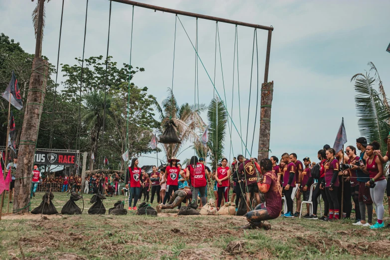 a group of people standing around in the mud