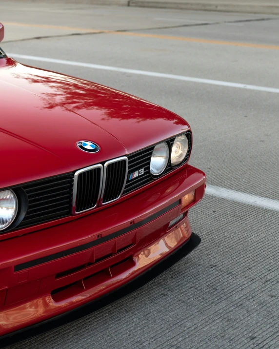 a red car is driving on a street