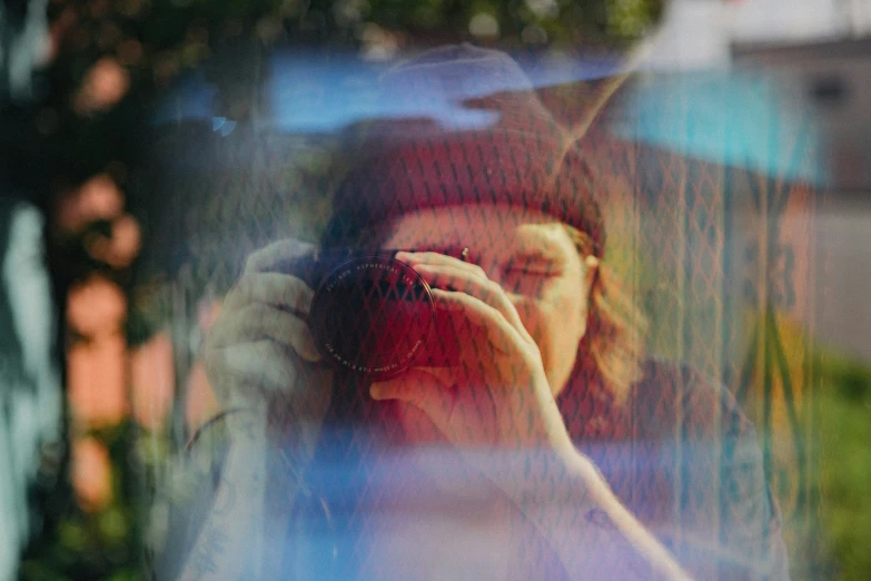 a woman standing behind a building taking a po