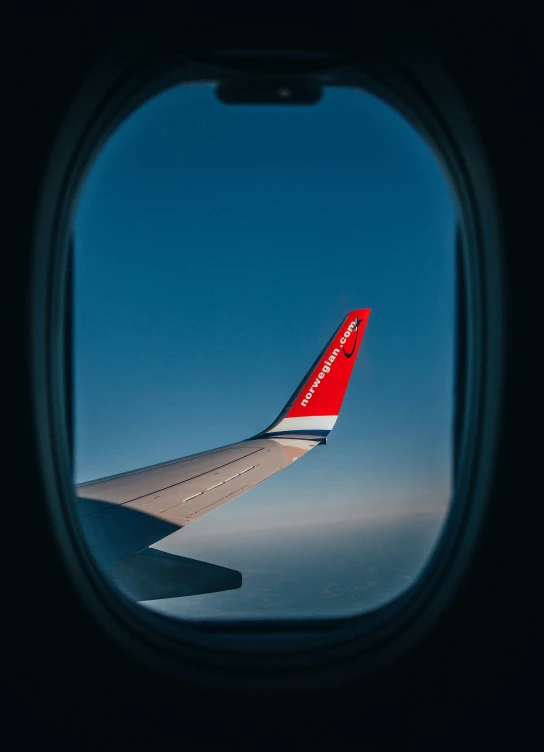 an airplane wing seen through the window in flight