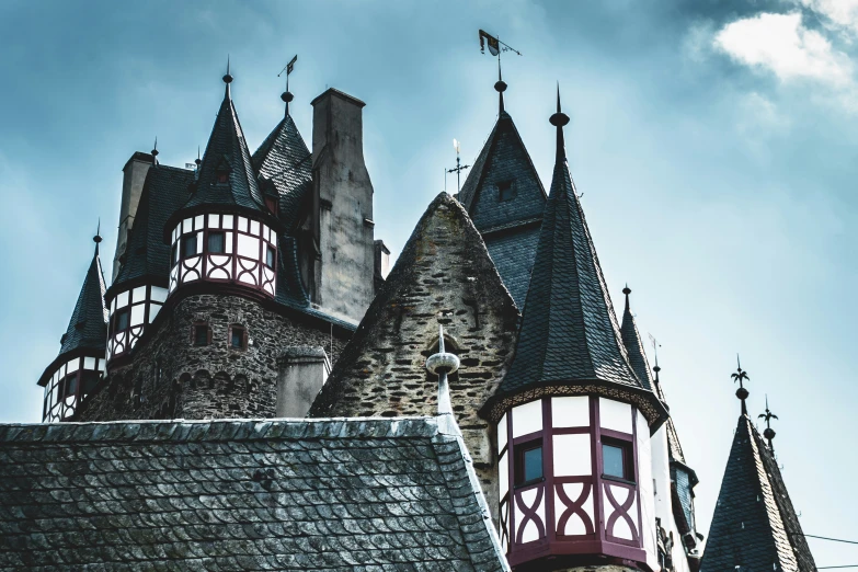 two towers and two windows on the top of a building