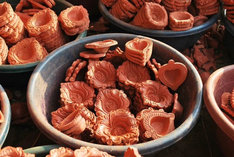 bowls with carved clay heart shapes and shells