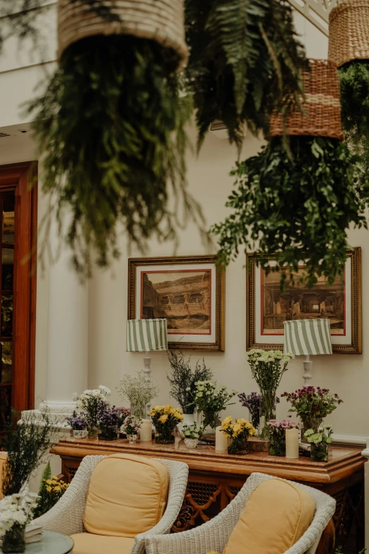 floral arrangements on a table with couches and chairs