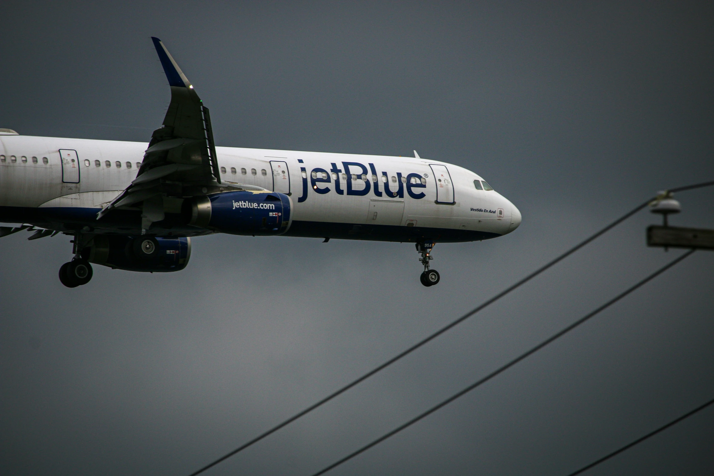 blue and white commercial airplane flying in the sky