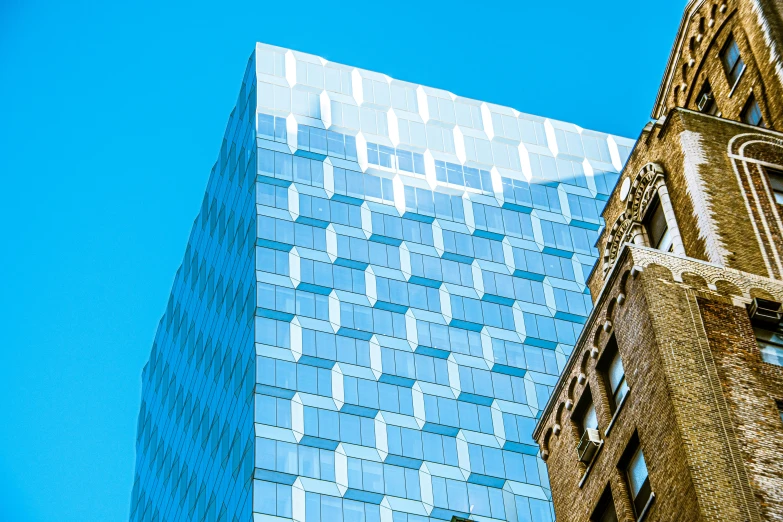 a tall building next to a very big shiny building