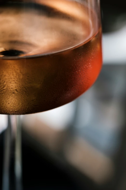 a close up of a glass of wine on a table