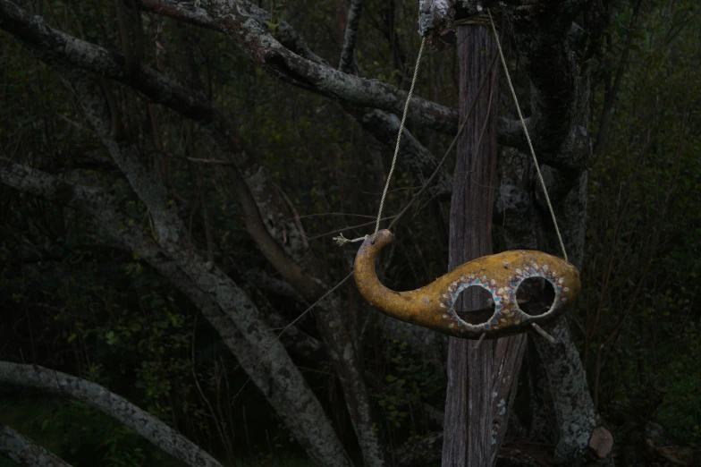 a close up of an animal shaped decoration hanging from a pole