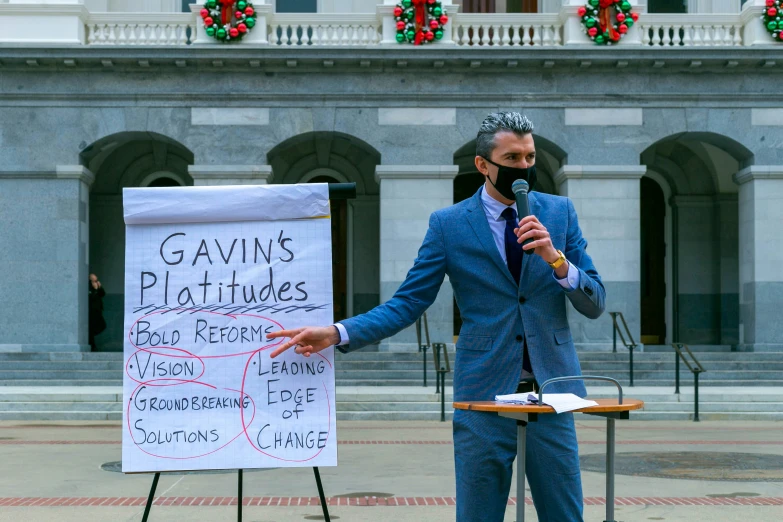 a person is speaking at a political rally