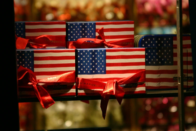 two decorated gift boxes with red, white and blue ribbons