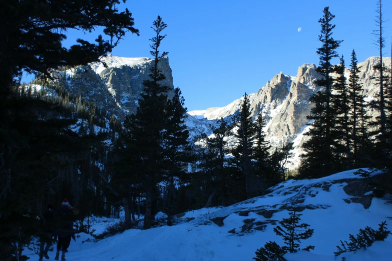 a man on skis is standing at the edge of the mountains