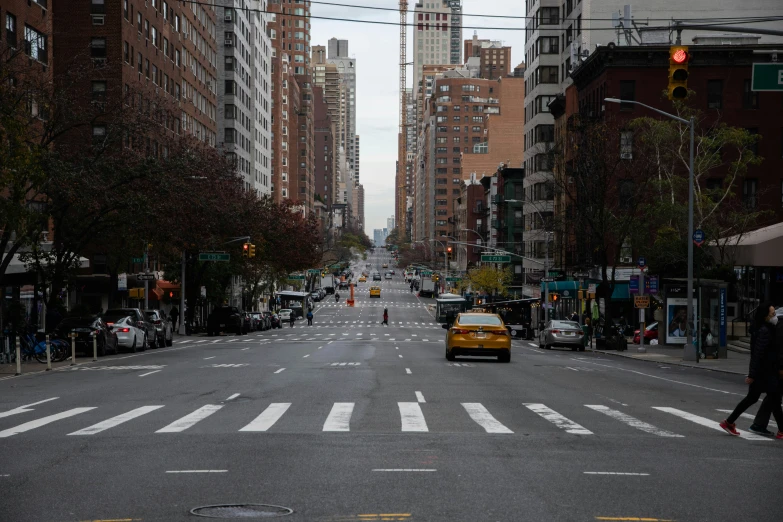 a city street with two people and buildings in the background