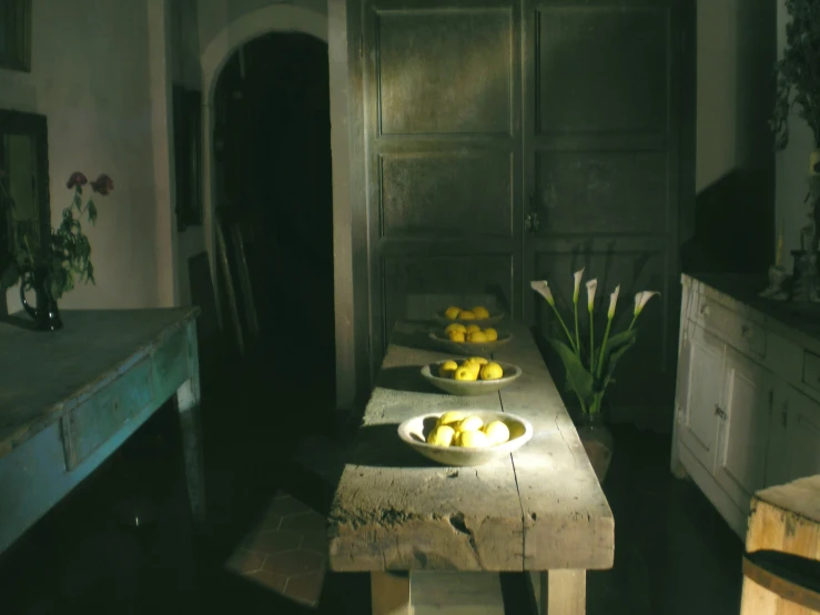 a kitchen with some fruit on a plate and another bowl on a table