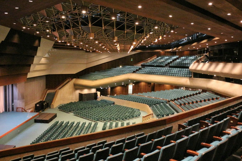 a empty auditorium filled with blue seats