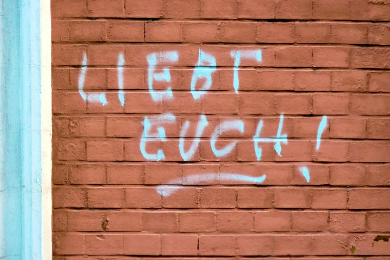 graffiti writing on a wall, reading i eat laugh