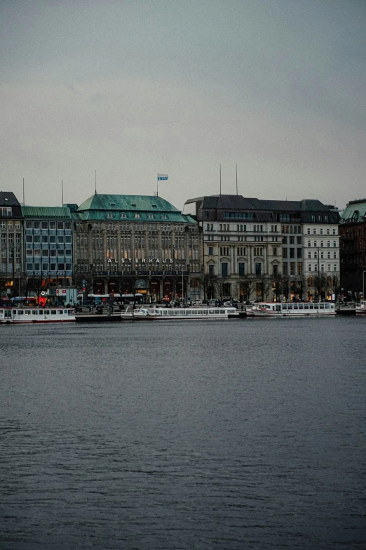 a boat floating in a river near a large city