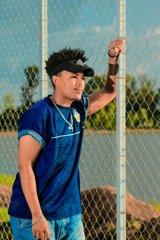 a man is taking a selfie behind a fence