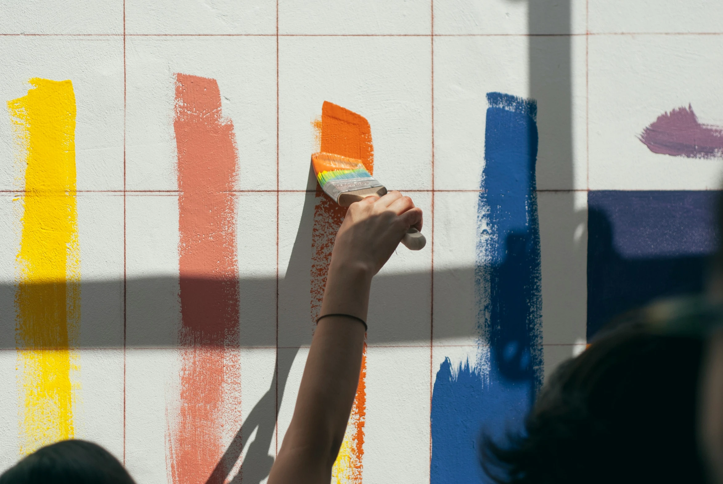 woman brushing off the walls with brush