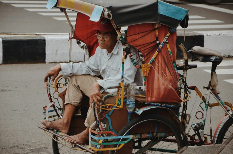 a man sitting on a bike that is holding a basket