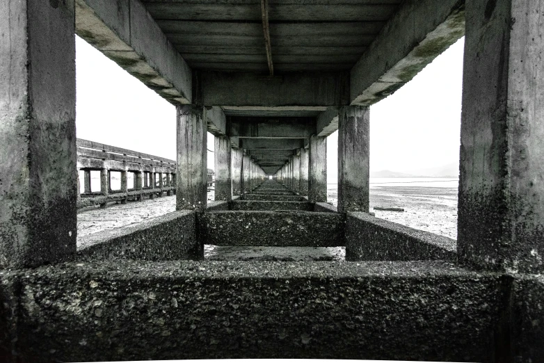 perspective of the underside of an overpass looking into a desert